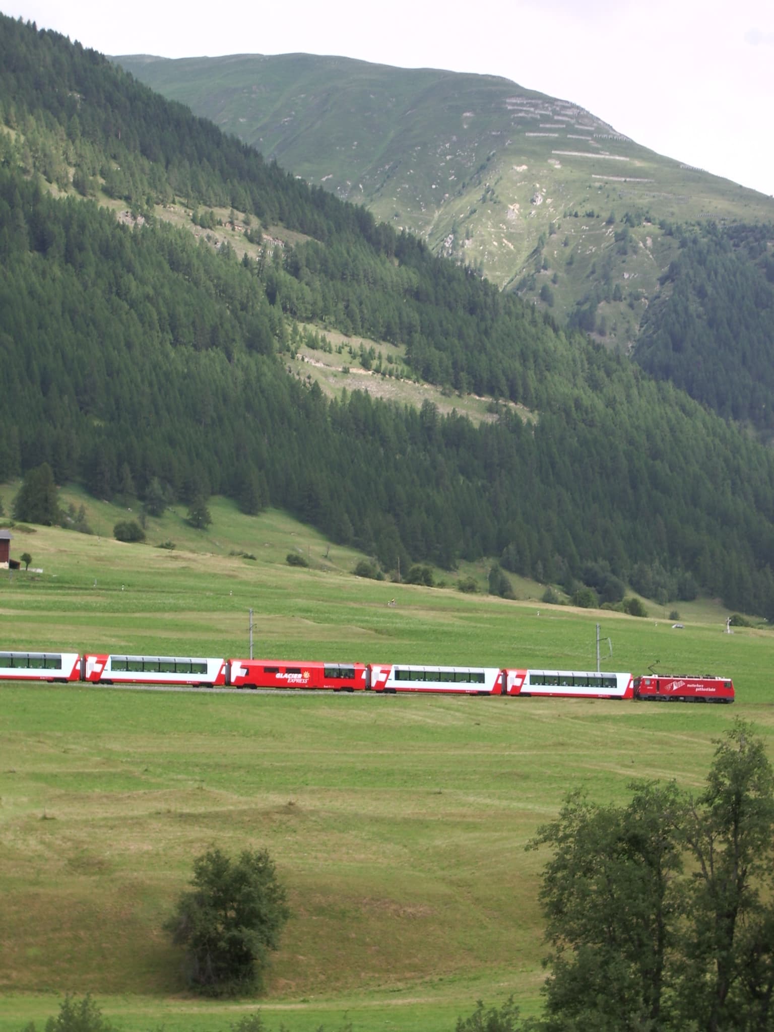 Glacier Express train east of Andermatt in Swiss Alps en route to Zermatt
