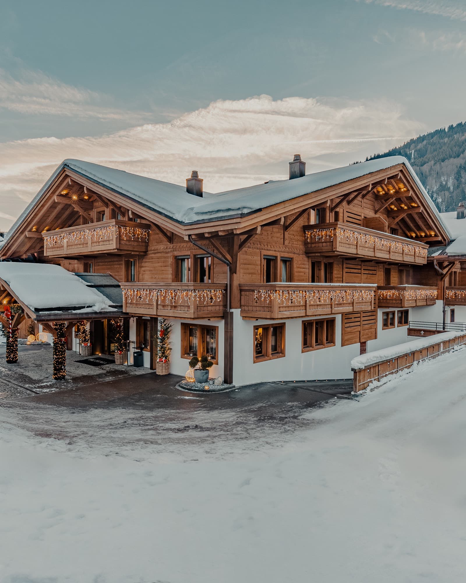 Snow-covered chalet in Gstaad surrounded by winter mountains