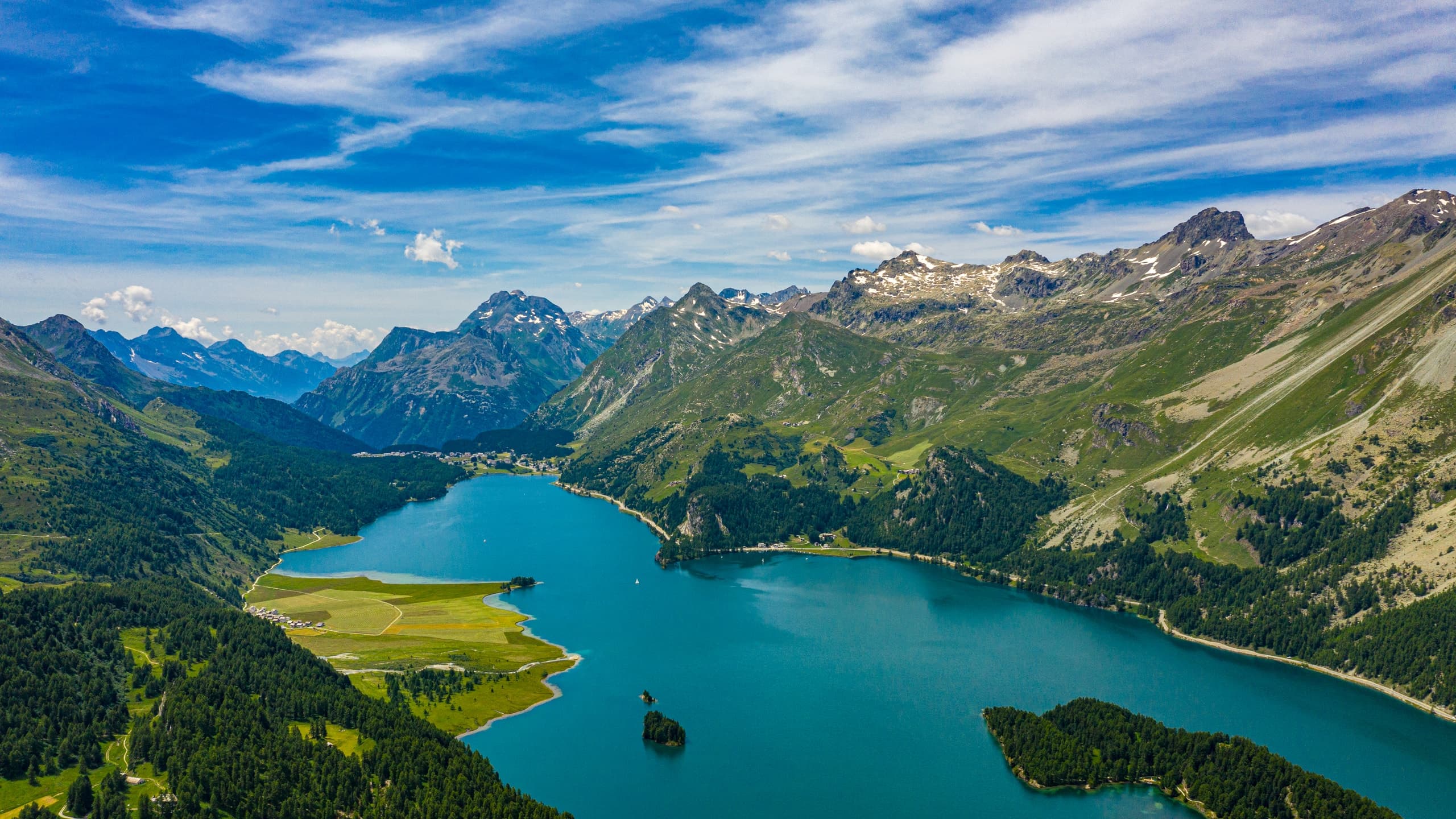 Aerial view over Lake Sils and the Upper Engadin mountains in summer